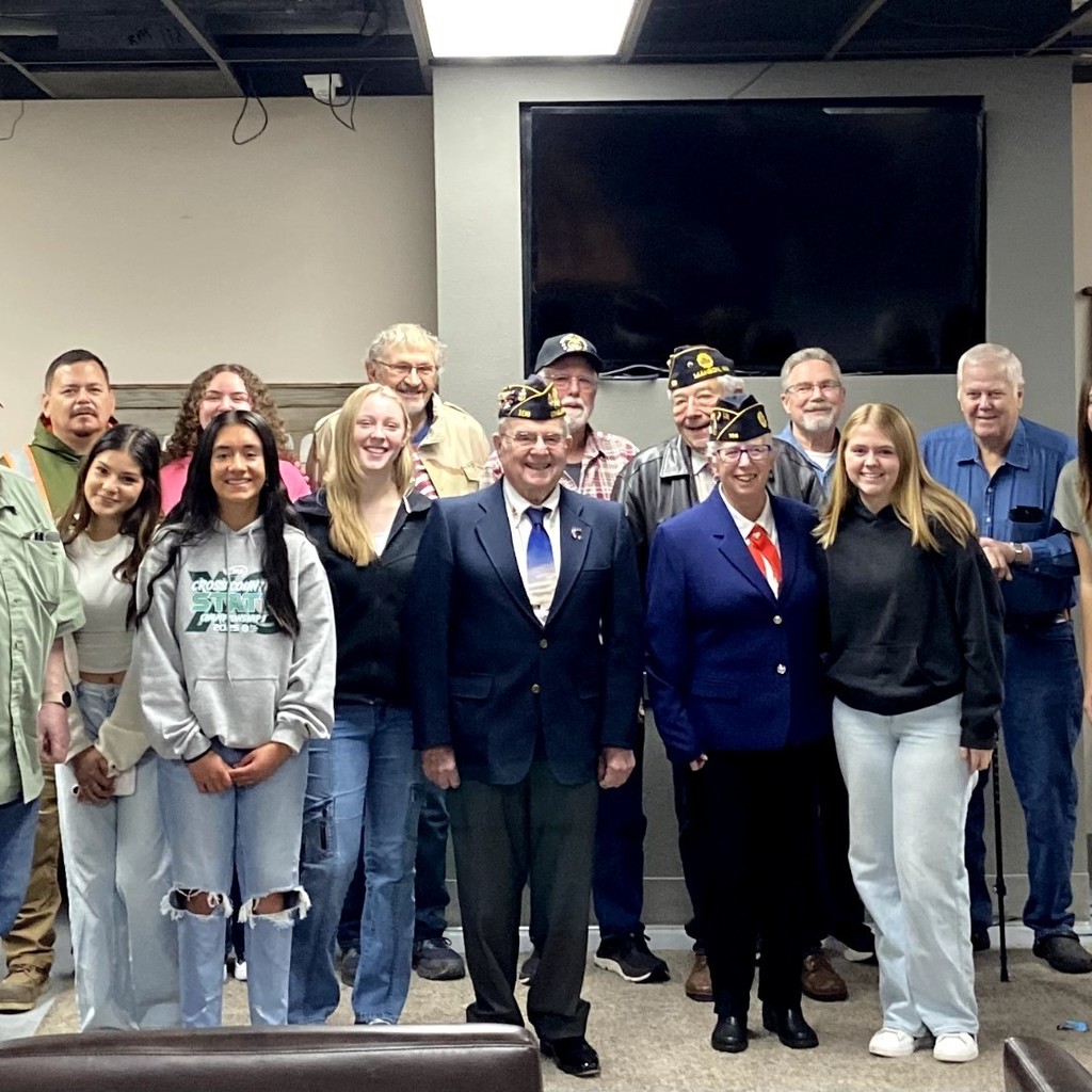 A group of veterans pose with stdents at Veterans Day Breakfast.