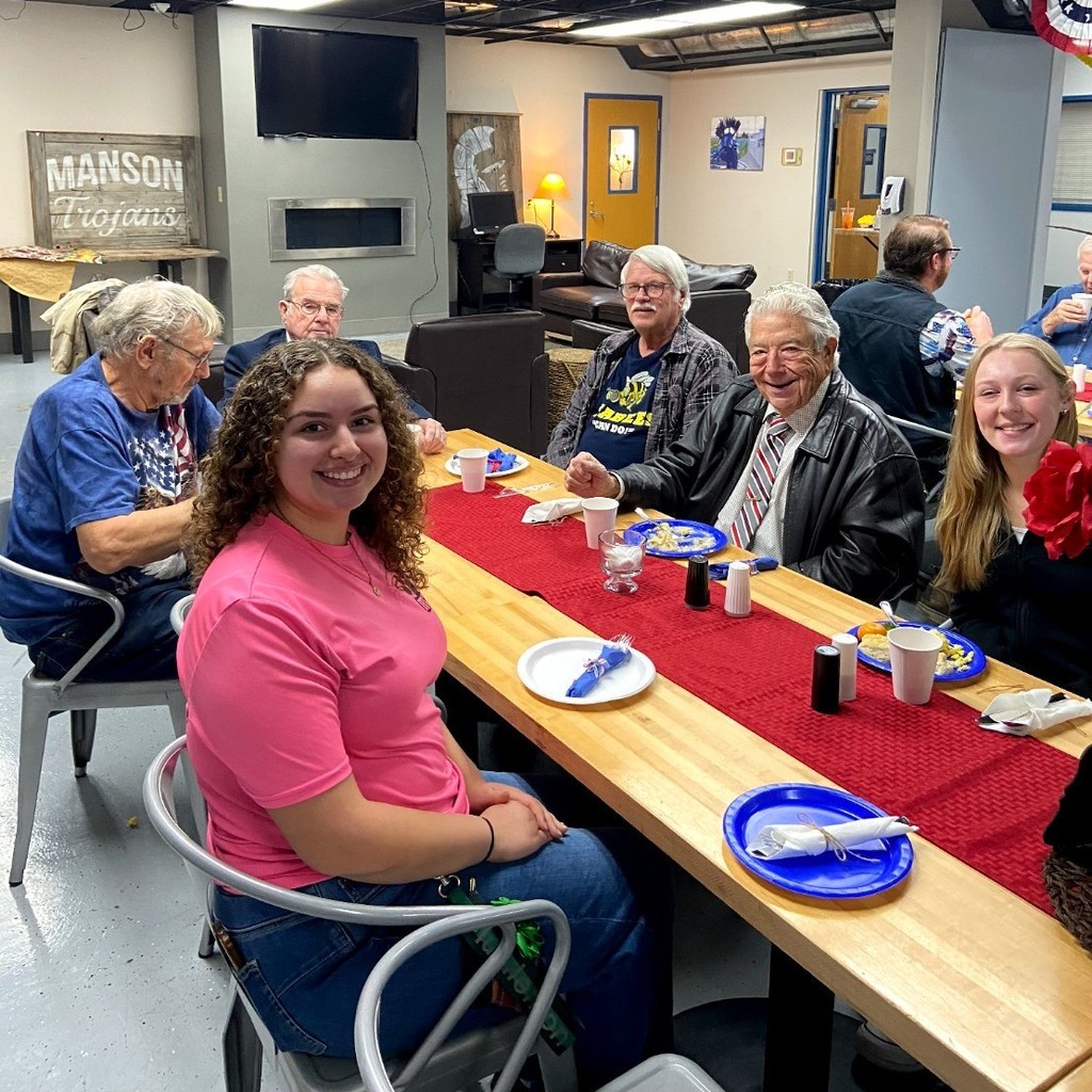 Three students share stories with veterans.