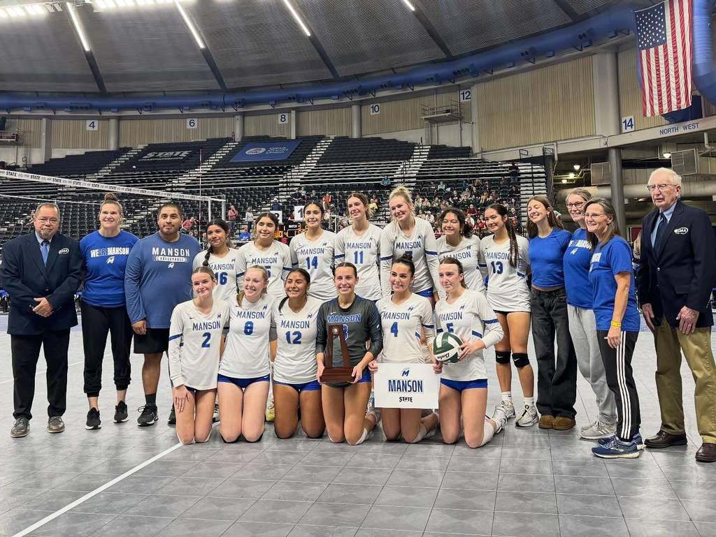 Volleyball team poses with fourth-place trophy.