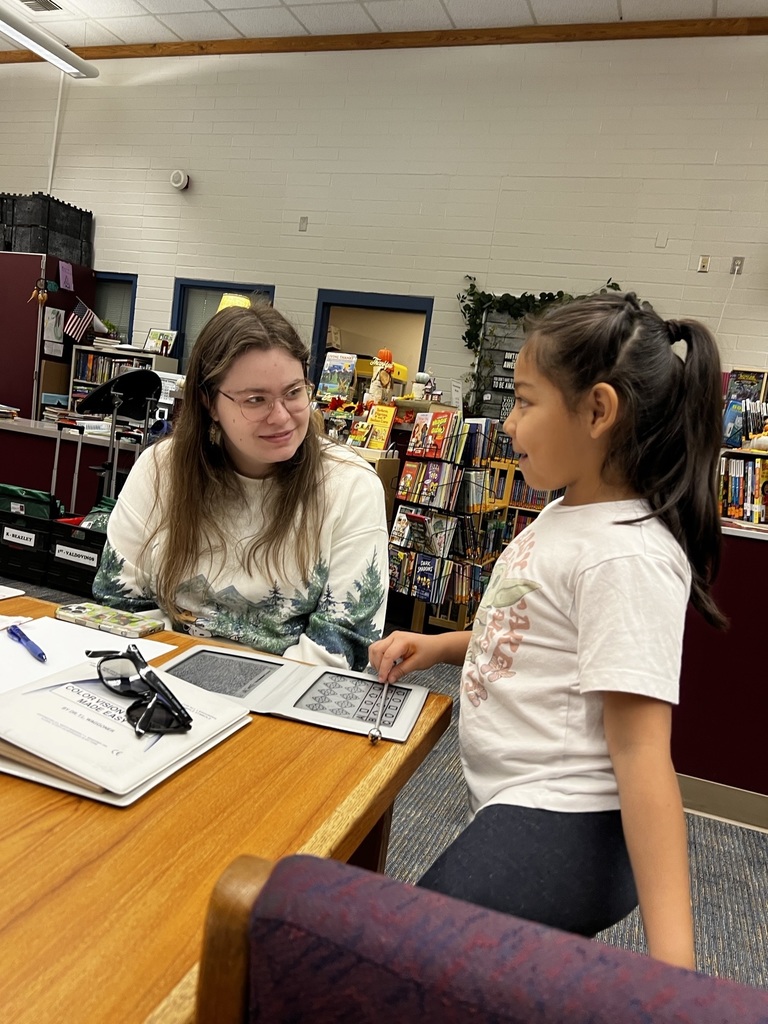 Dr. Pearson's assistant performs an eye exam with a student.