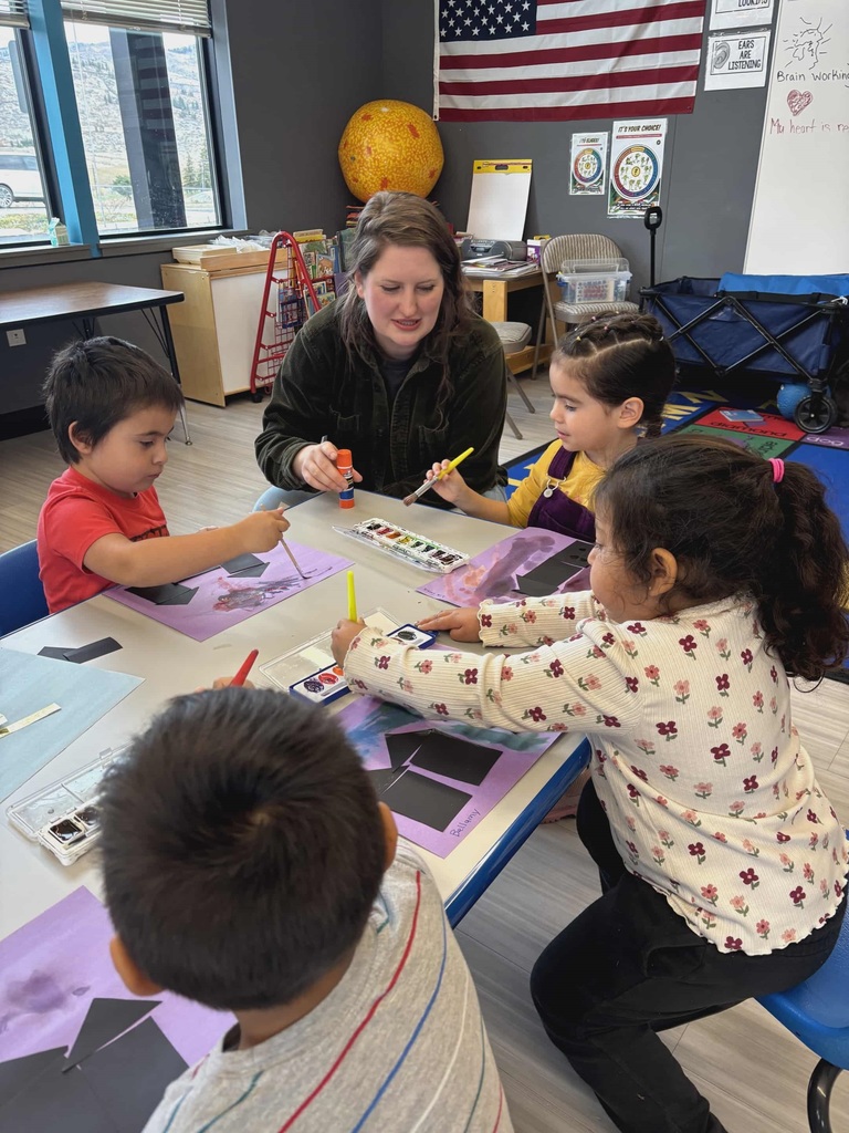 Students paint the solar system at the Early Learning Center.
