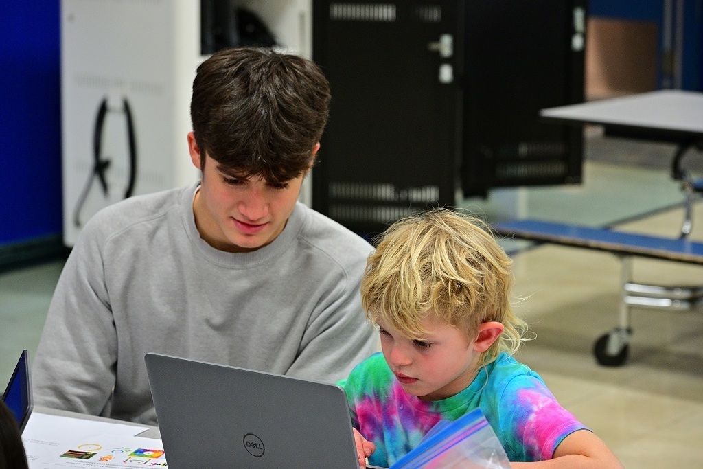 Elementary student is absorbed by computer screen.