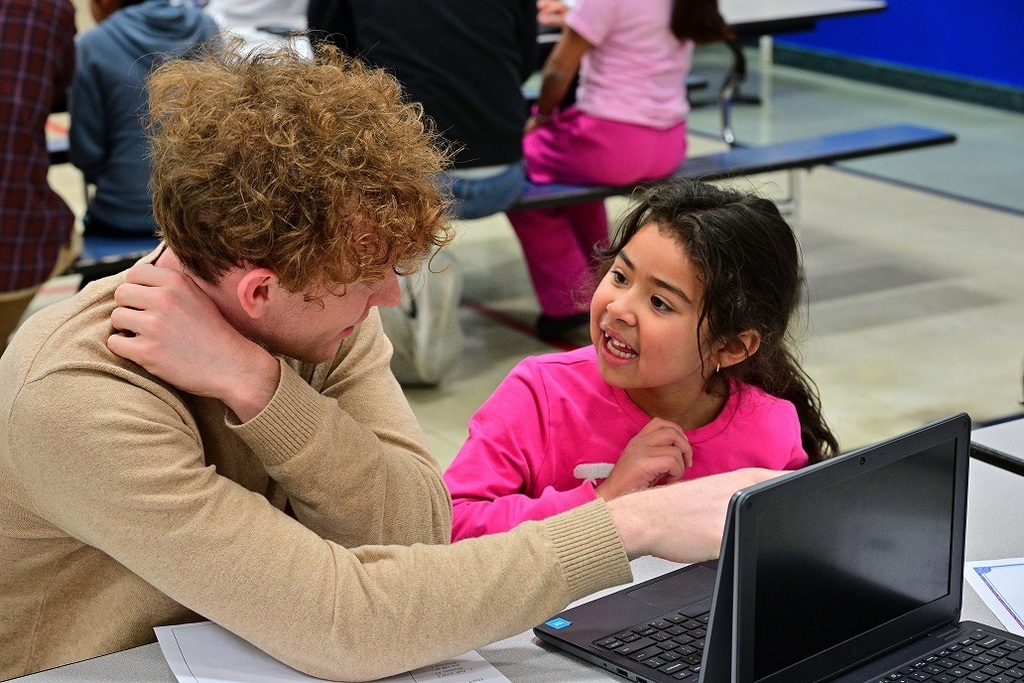 Two students in conversation at a computer