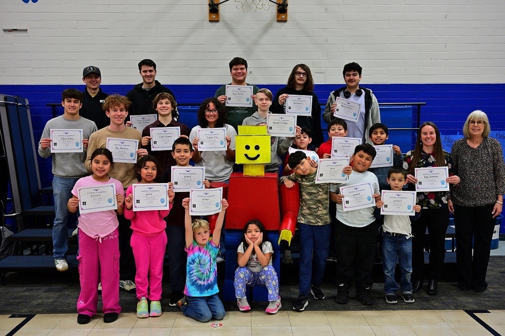 Robotics and AI students stand together for a photo.