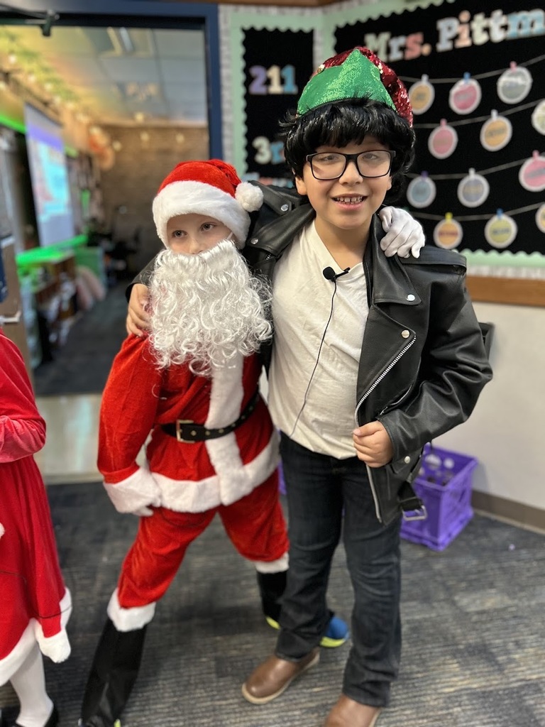 Santa and Elves pose together.