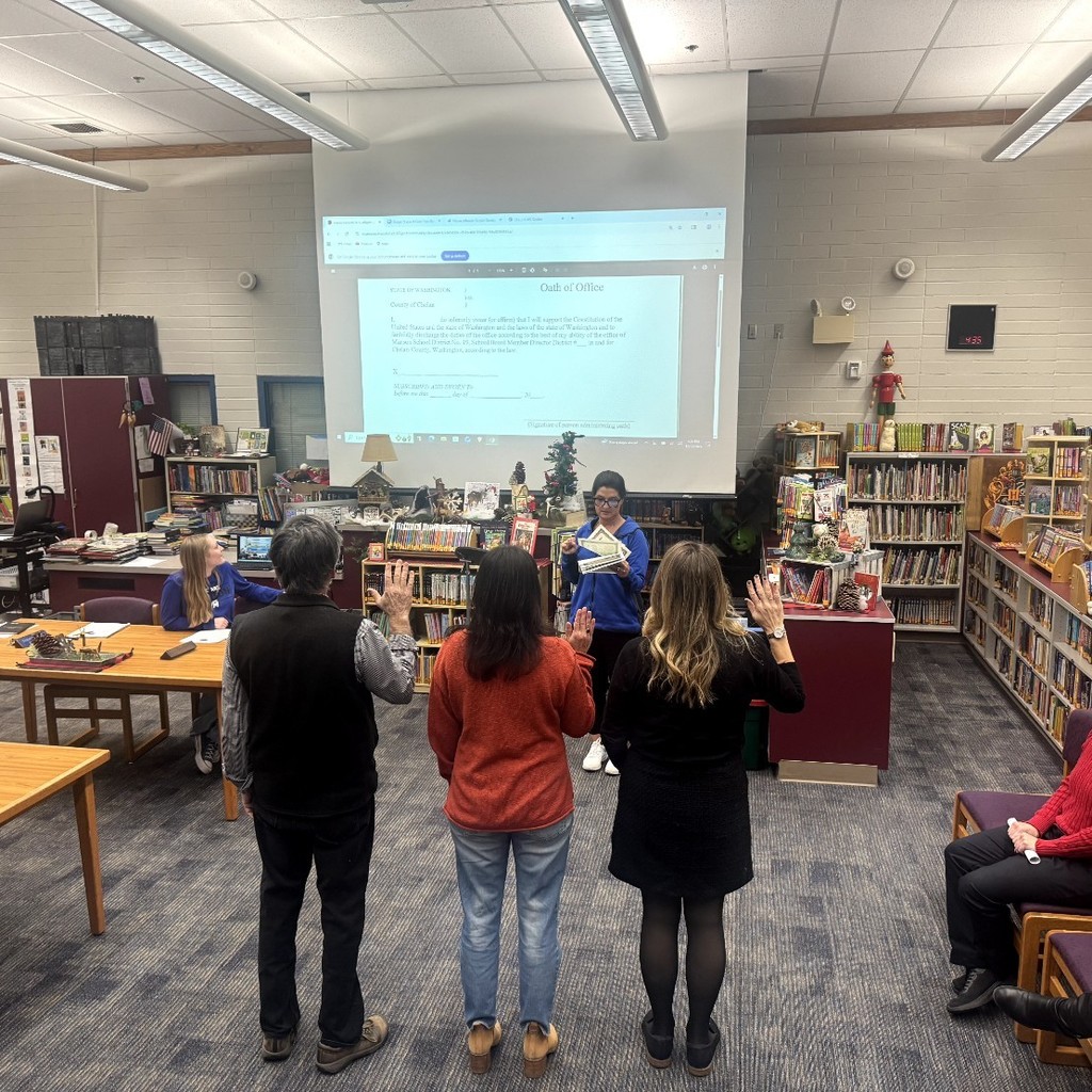 Three board members take the oath of office.