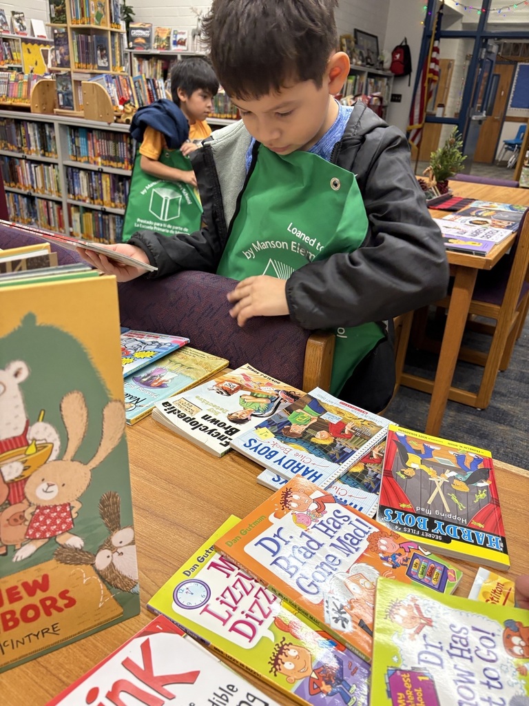 A boy digs through a selection of books.