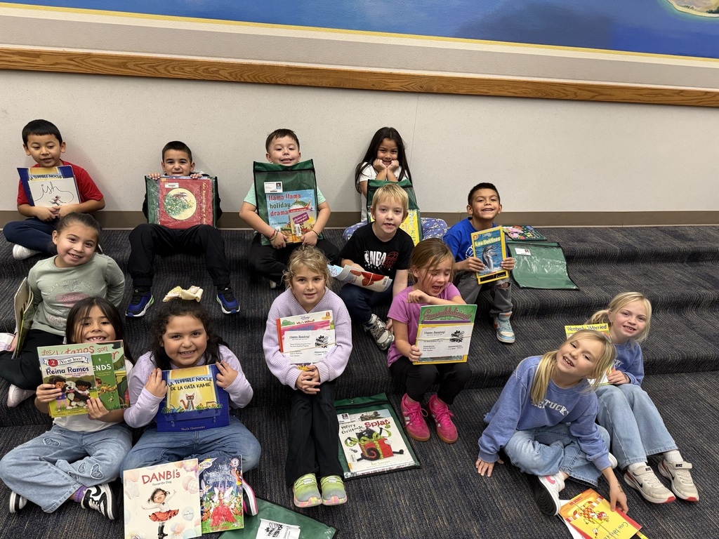 A whole class shows off their new book.