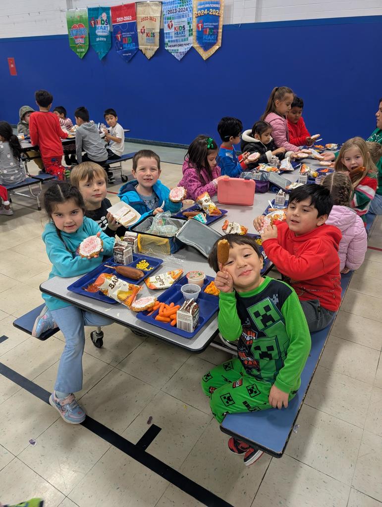 Student show off their Christmas cookies at the lunch table.