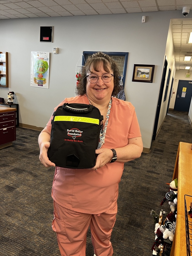 School nurse Michelle Rogge holds an AED donated to the school district by the Devid Heller Foundation.
