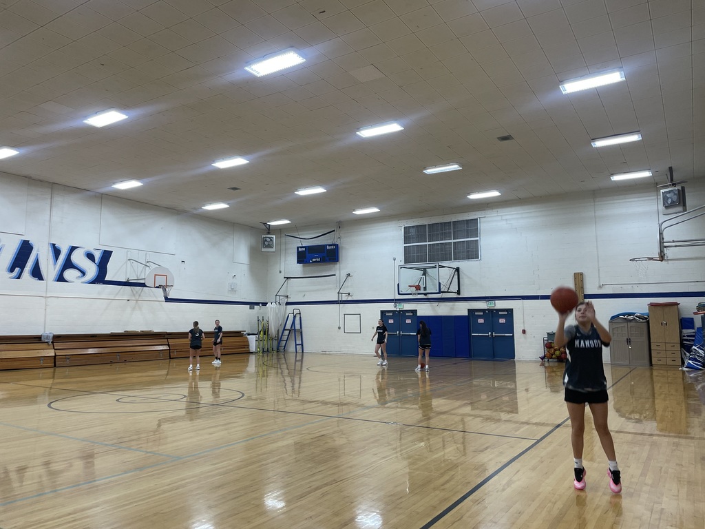 Girl shooting a basket in the Manson gym.