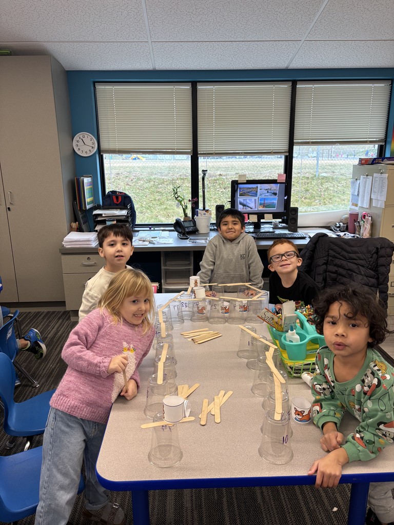 Students use popsicle sticks to build bridges.