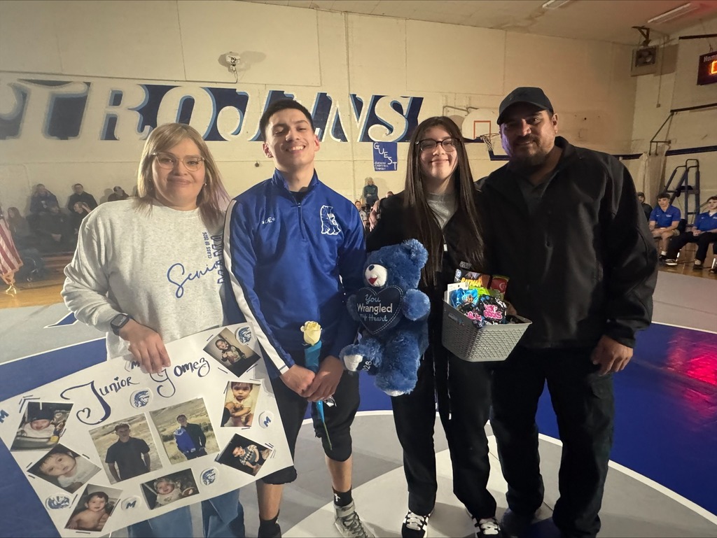 A senior and his family pictured in the gym.