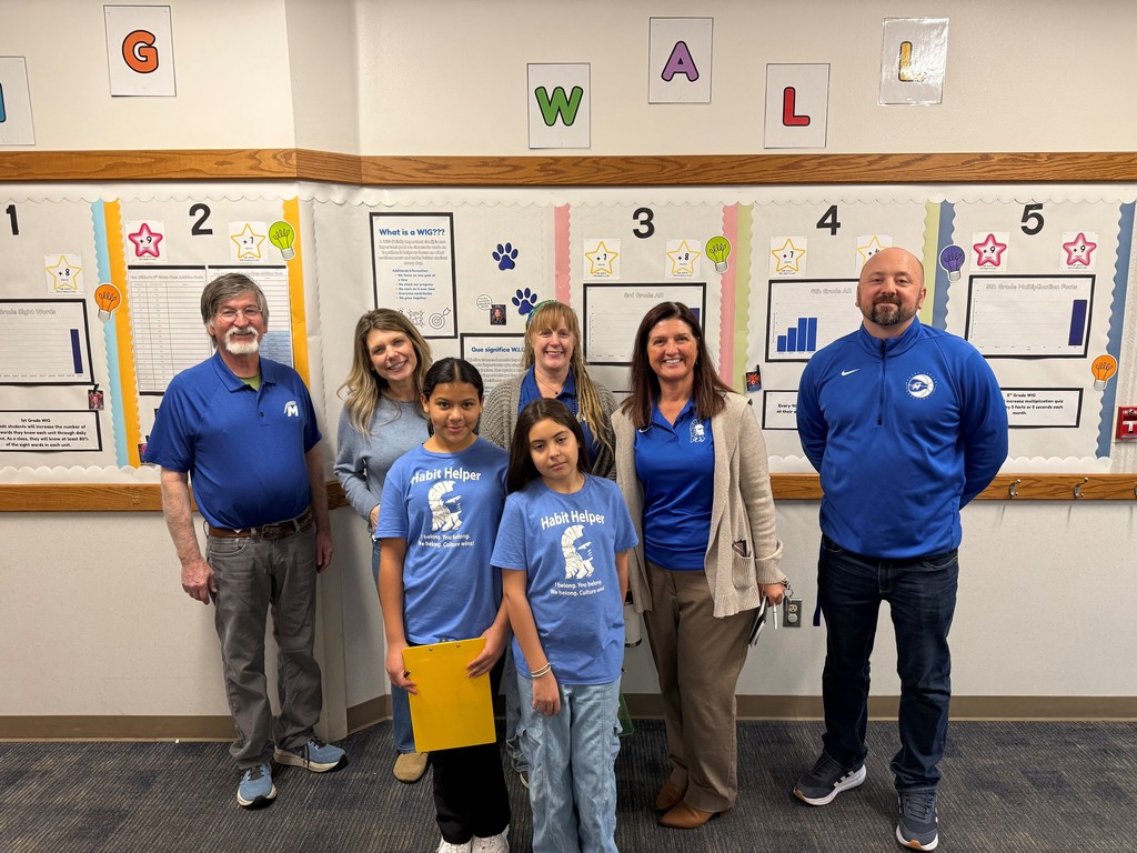 Board members and student guides tour Manson Elementary School.