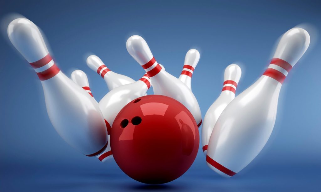 Bowling ball knocking down pins