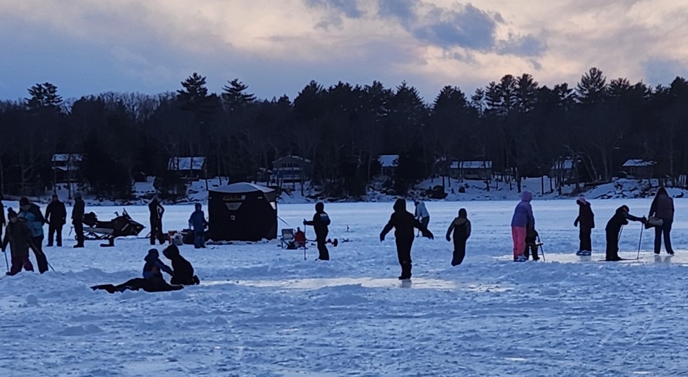 Families enjoying ice fishing, skating and cross country skiing.