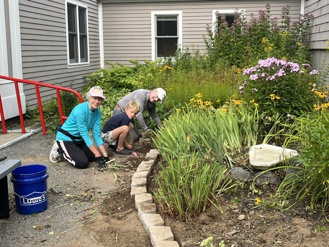 Community members weeding the school garden. 