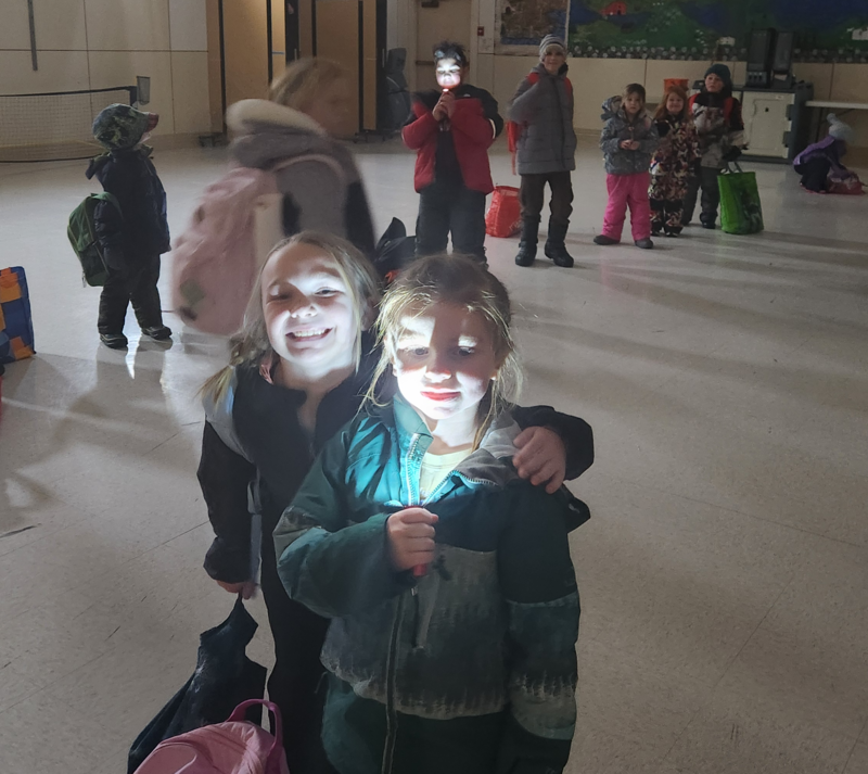 Children playing with flashlights. 