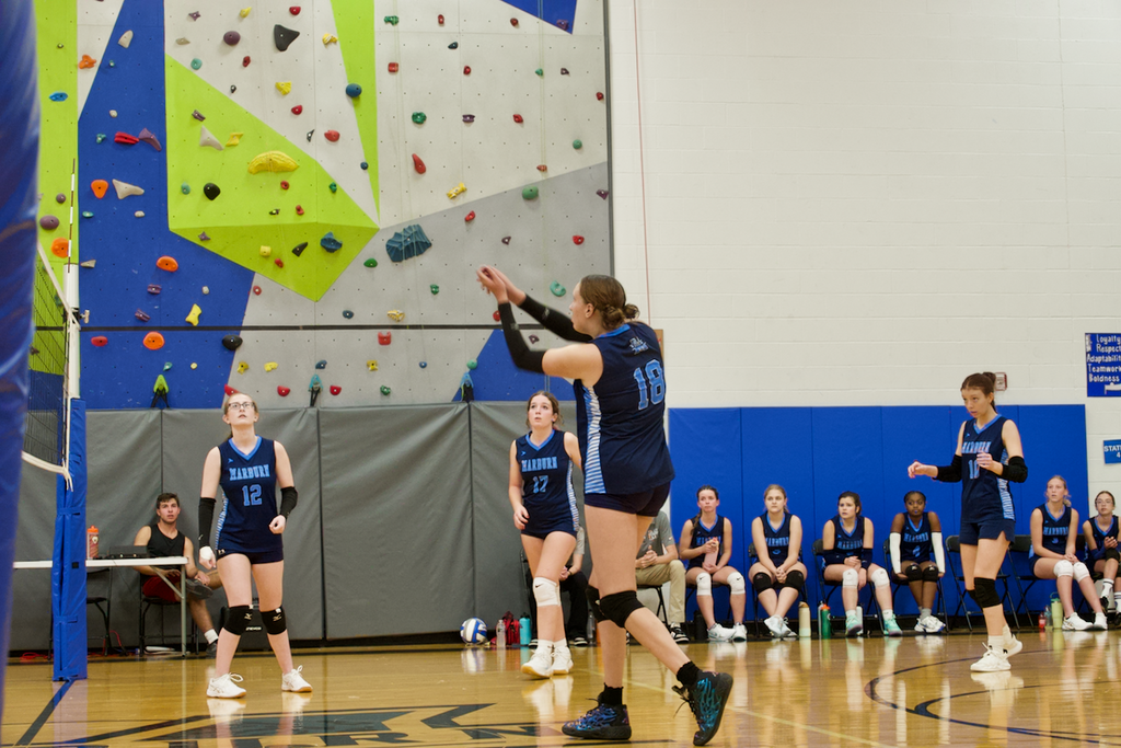 Marburn Volleyball  players watching a teammate hit a ball