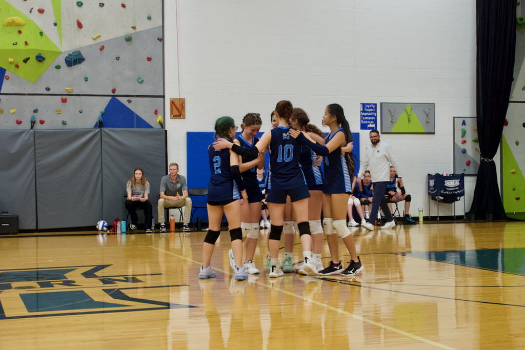 Marburn Volleyball  huddling up after scoring a point