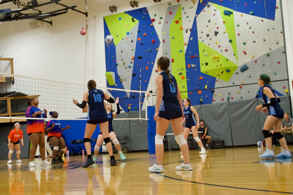 Marburn Volleyball player setting a ball as her teammates look on