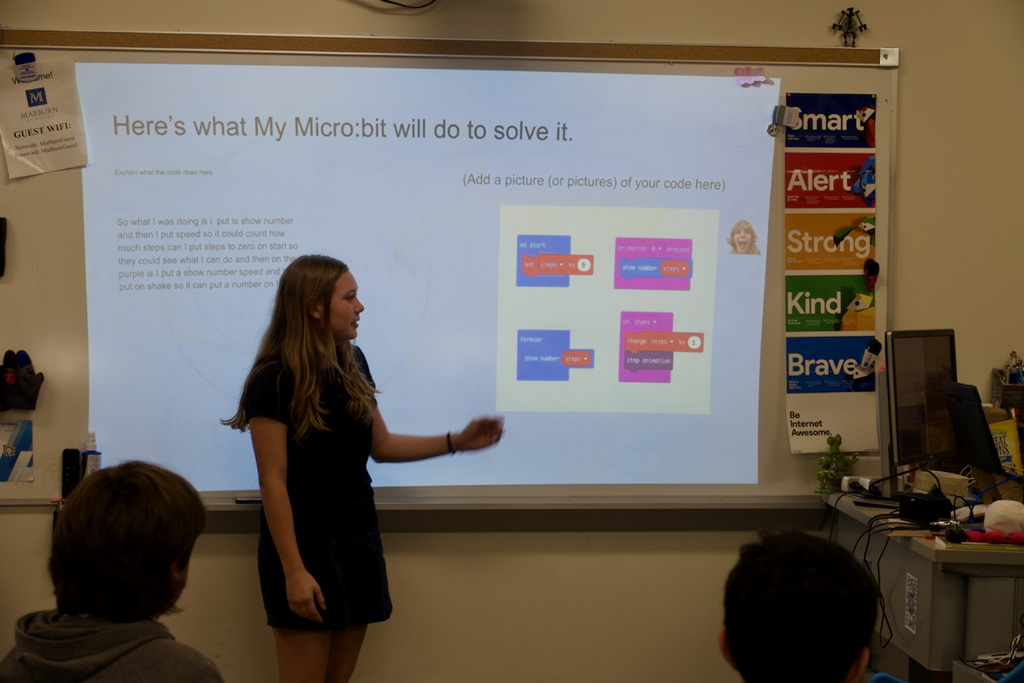 Female student standing in front of a presentation explaining coding at Marburn Academy