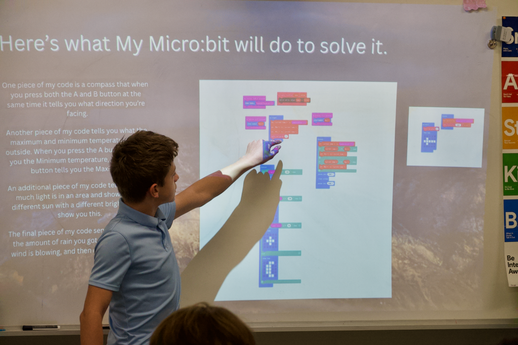 Student pointing at coding presentation at Marburn Academy.