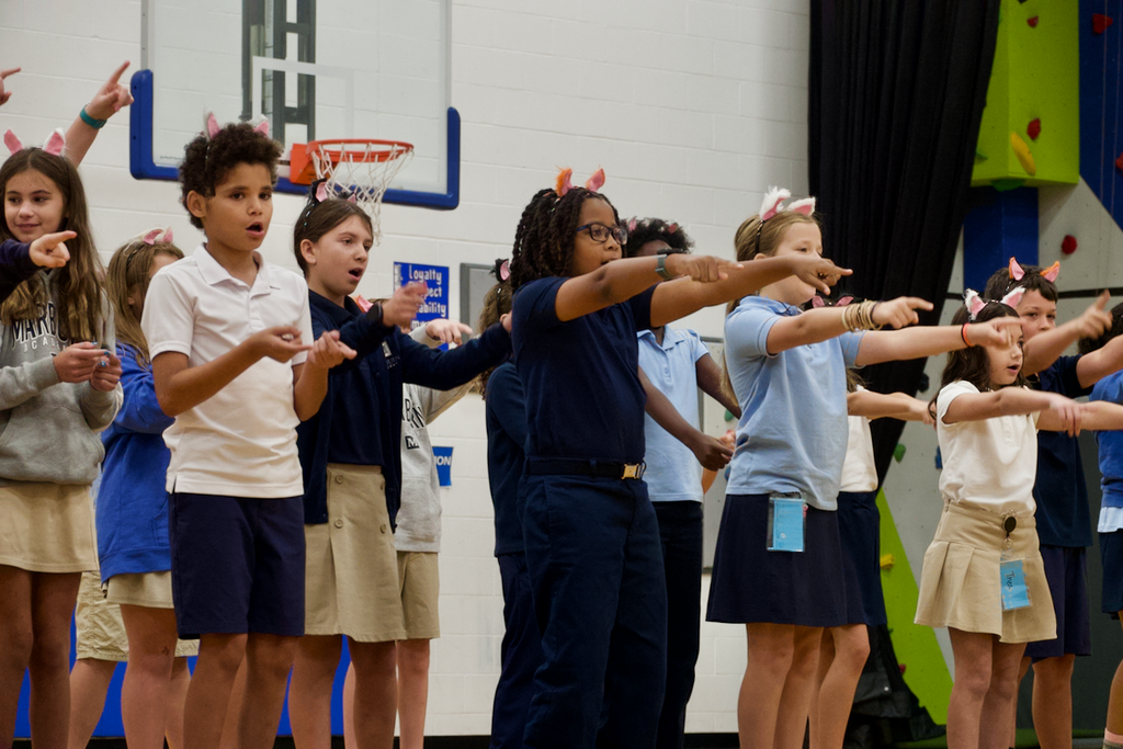 Students singing and performing, wearing cat ears.