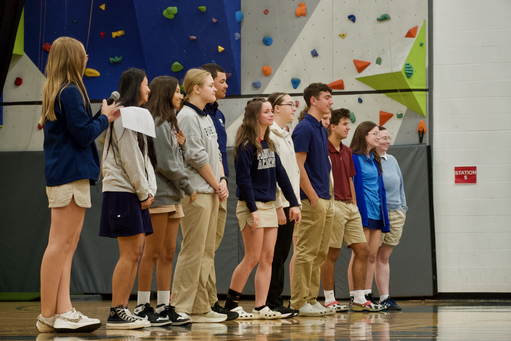 Students standing in a line smiling.