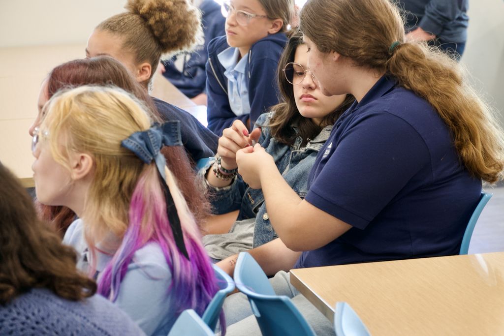 Students passing fossils to each other