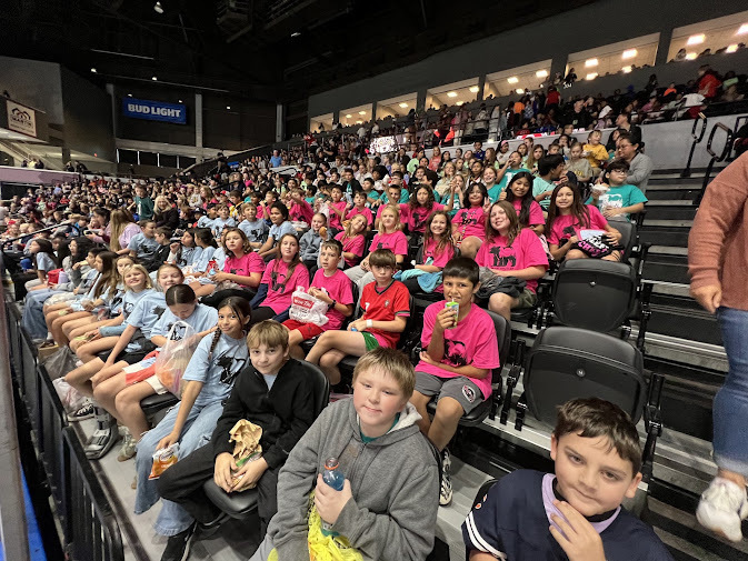 5th grand students in seats at ice hogs game