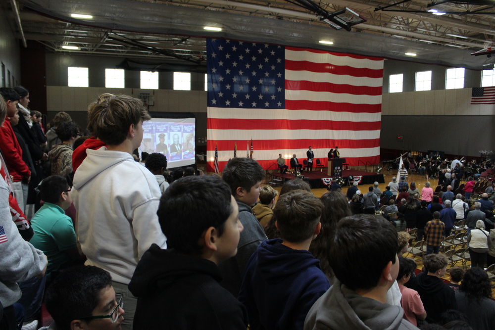 Students at Veterans day program in bleachers 