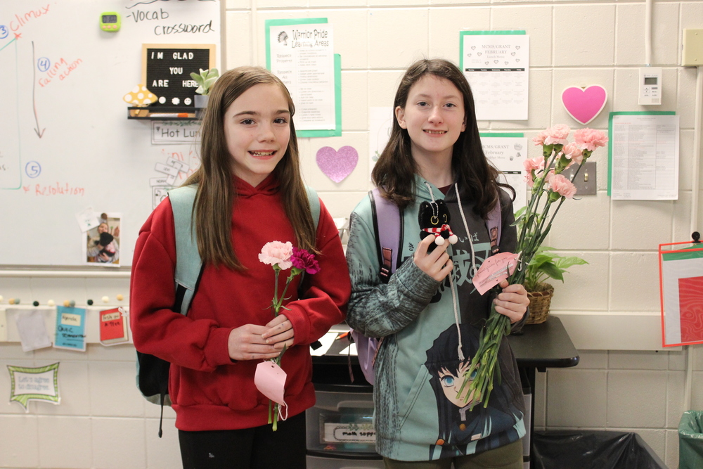 two students with carnations 
