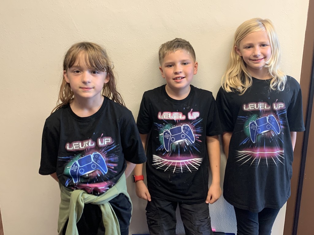 3 students dressed in matching video game t-shirts for spirit week.