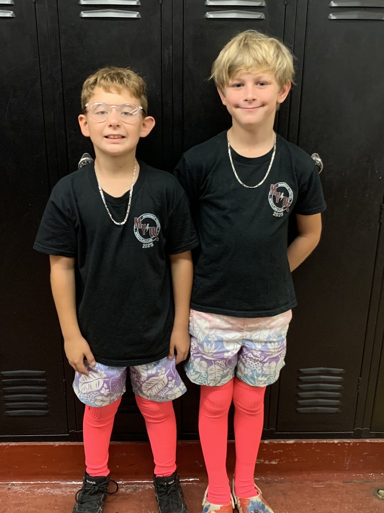 Two studetns dressed in matching tshirts, shorts, and pink tights for twin day.