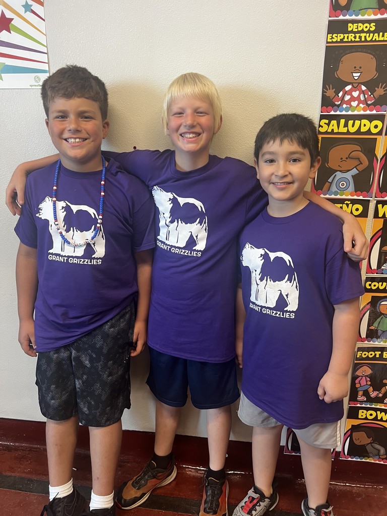 Three 5th grade students dressed in matching Grant purple tshirts for field trip