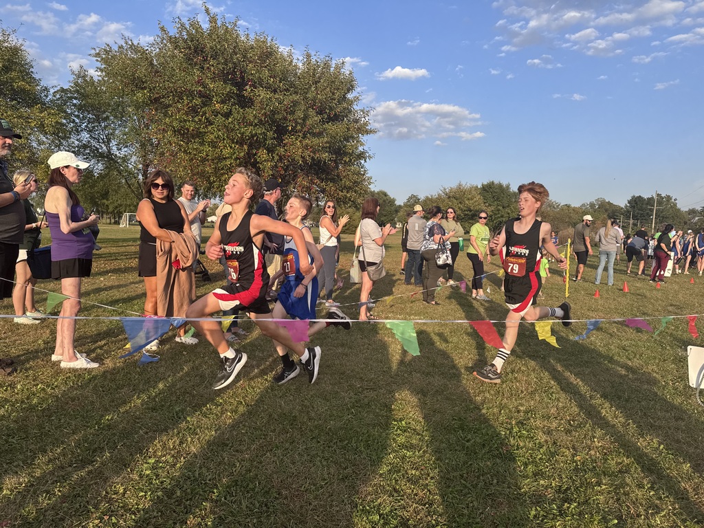 2 boys run to finish line