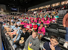 students at a hocky game wearing matching tshirts