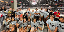 Mrs. Andersons 5th grade class on field trip to ice hog game posing