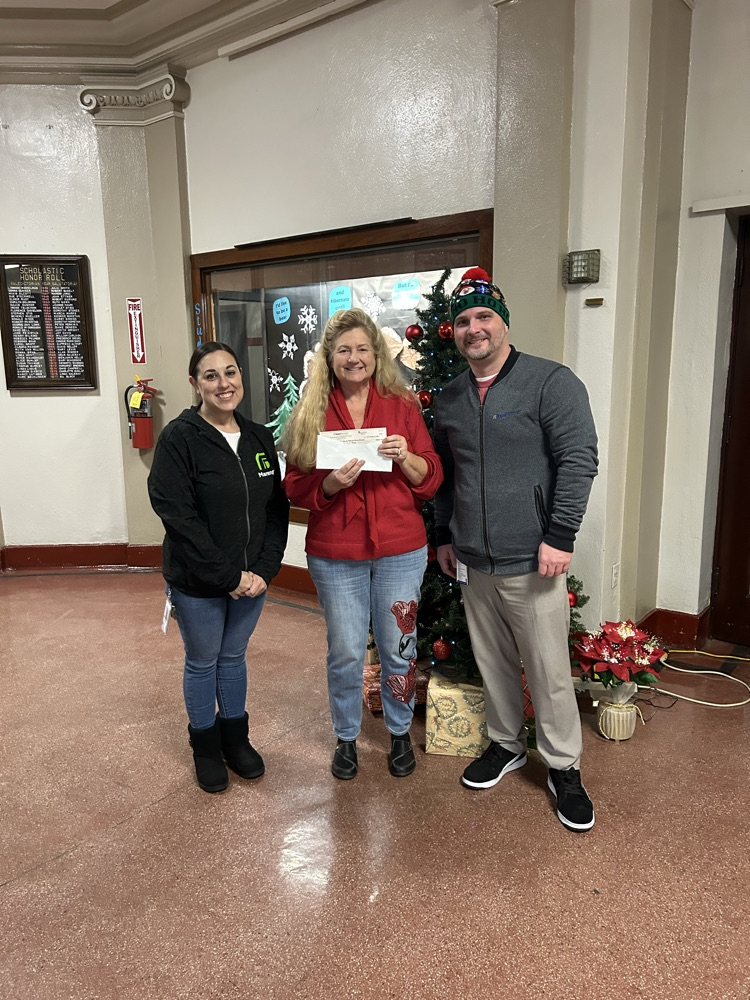 Representatives from Regal Rexnord presenting check to Dr. Damisch 