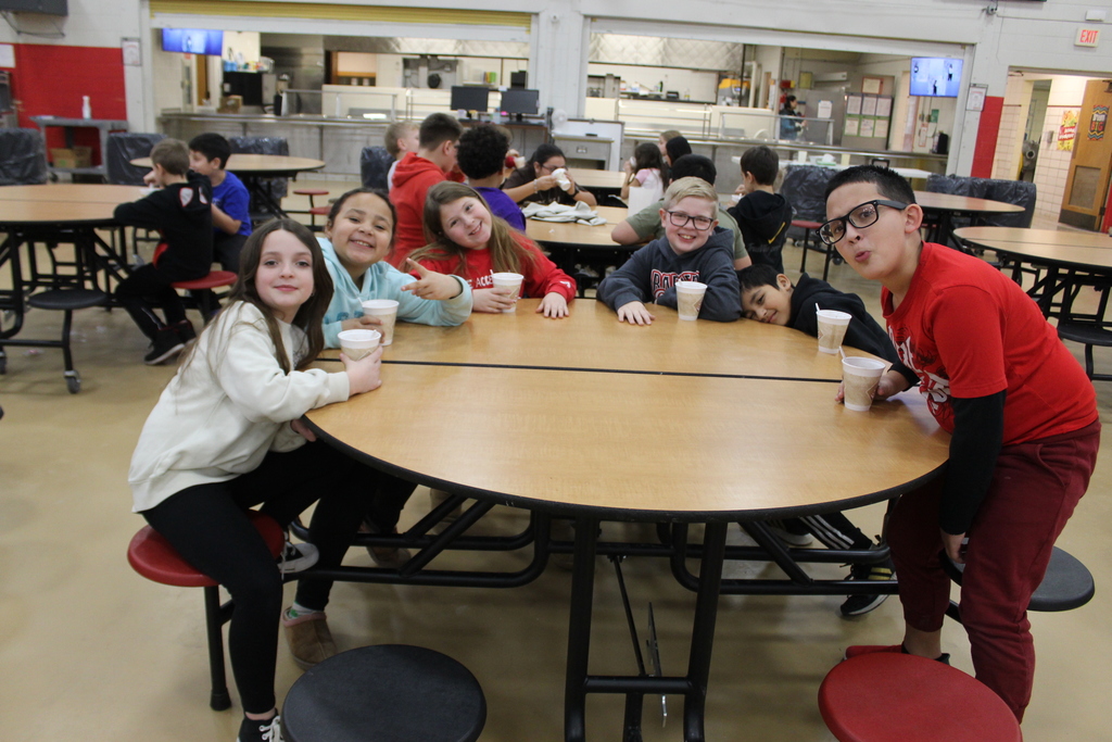 Students drinking hot chocolate at table 