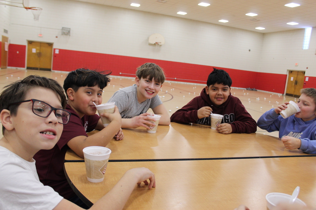 Students drinking hot chocolate at table 