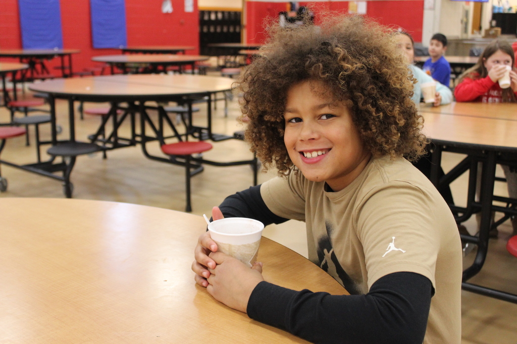 Students drinking hot chocolate at table 