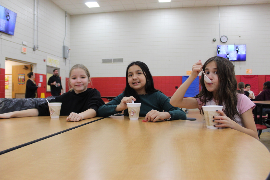 Students drinking hot chocolate at table 