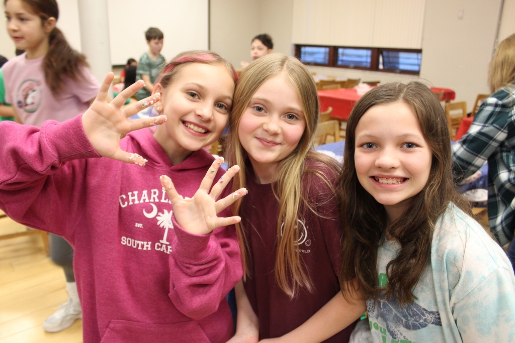 Students with frosting on fingers 