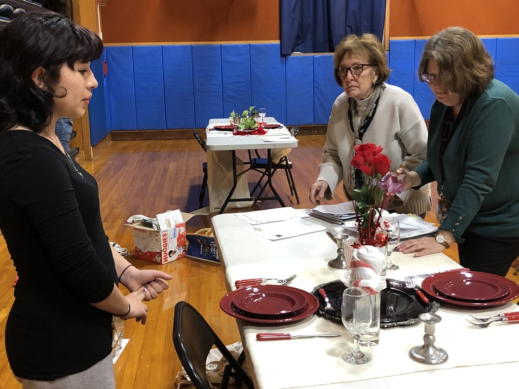 We have a pictures of our students in their competition events and our judges diligently looking over students work.