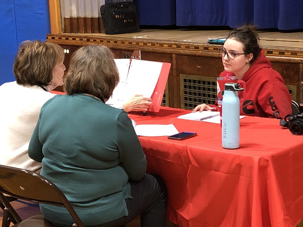 We have a pictures of our students in their competition events and our judges diligently looking over students work.