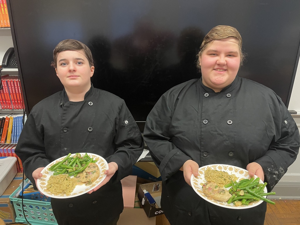 Culinary competitors showing off the food.