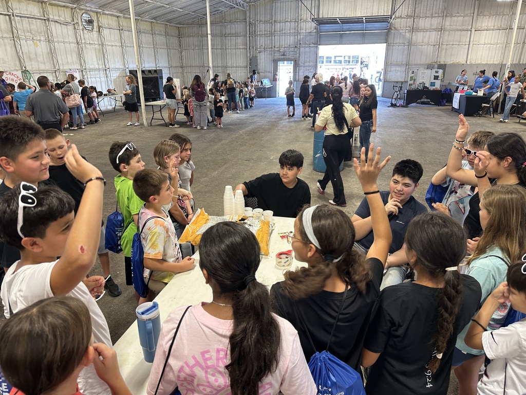 students gathered around a table for learning