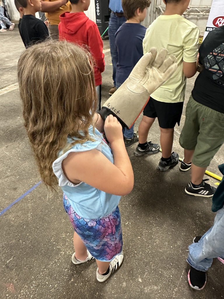 student trying on welding glove